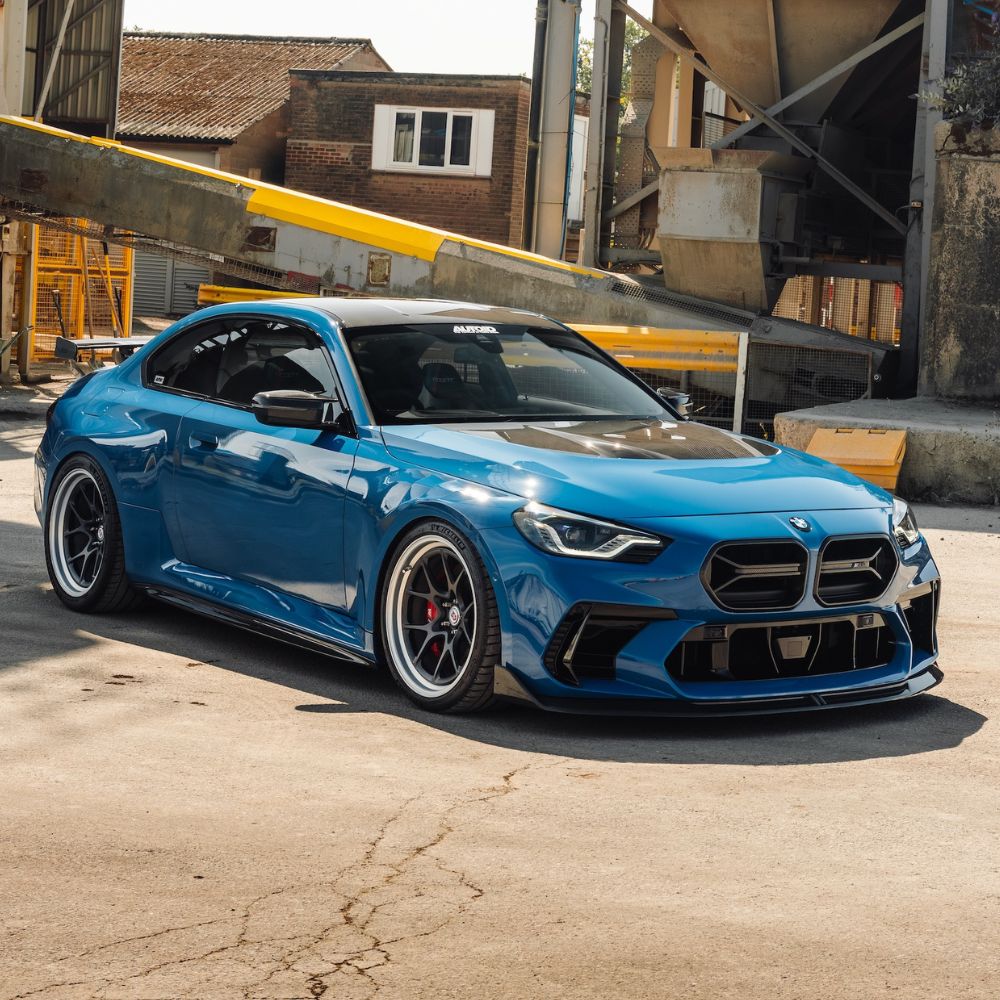Blue BMW G87 M2 parked in a stance position