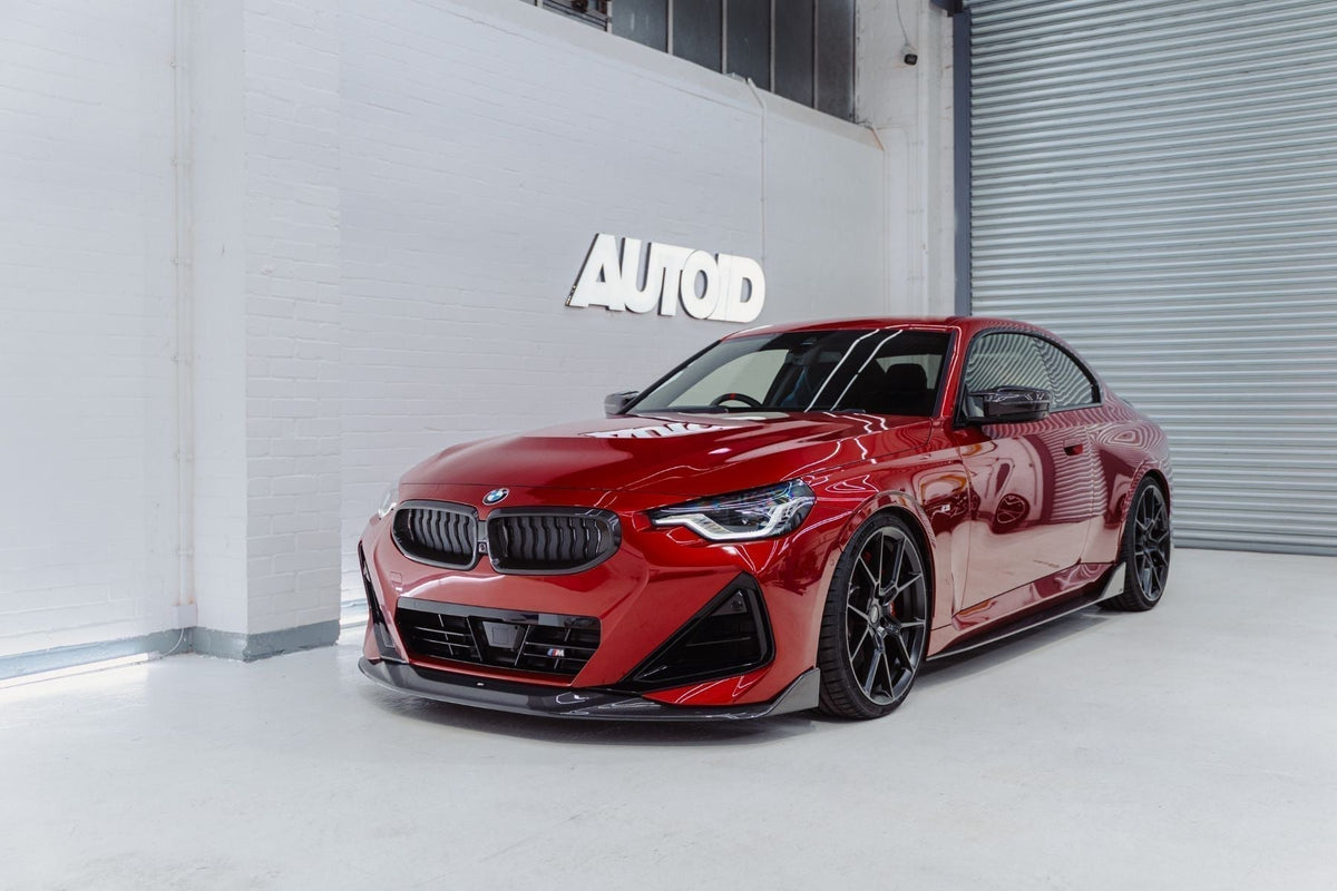 BMW G42 M240i red front three-quarter view with ADRO carbon fibre front splitter and side skirts