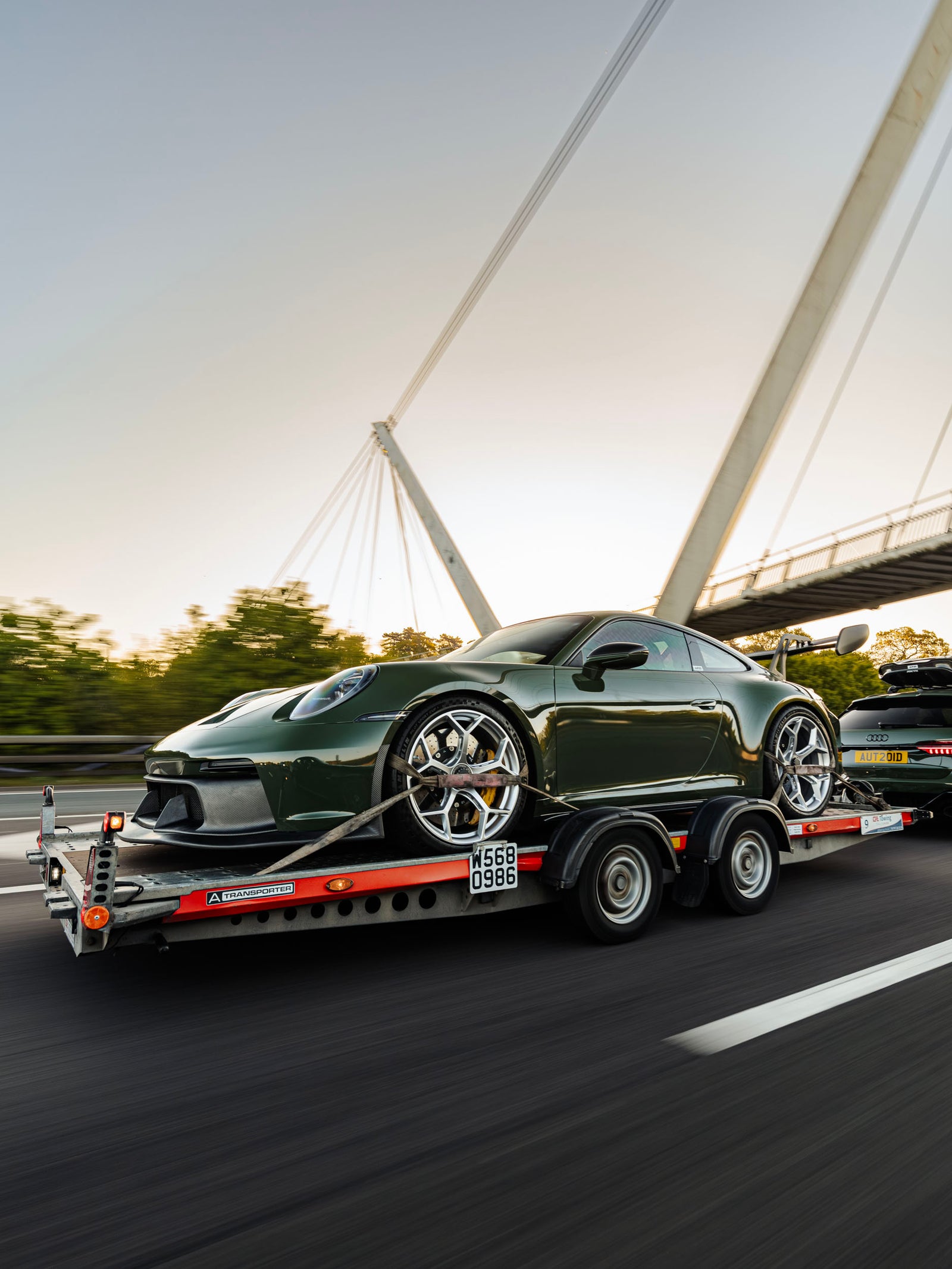 ADRO Porsche 992 911 GT3 on trailer towed by Audi RS6 C8