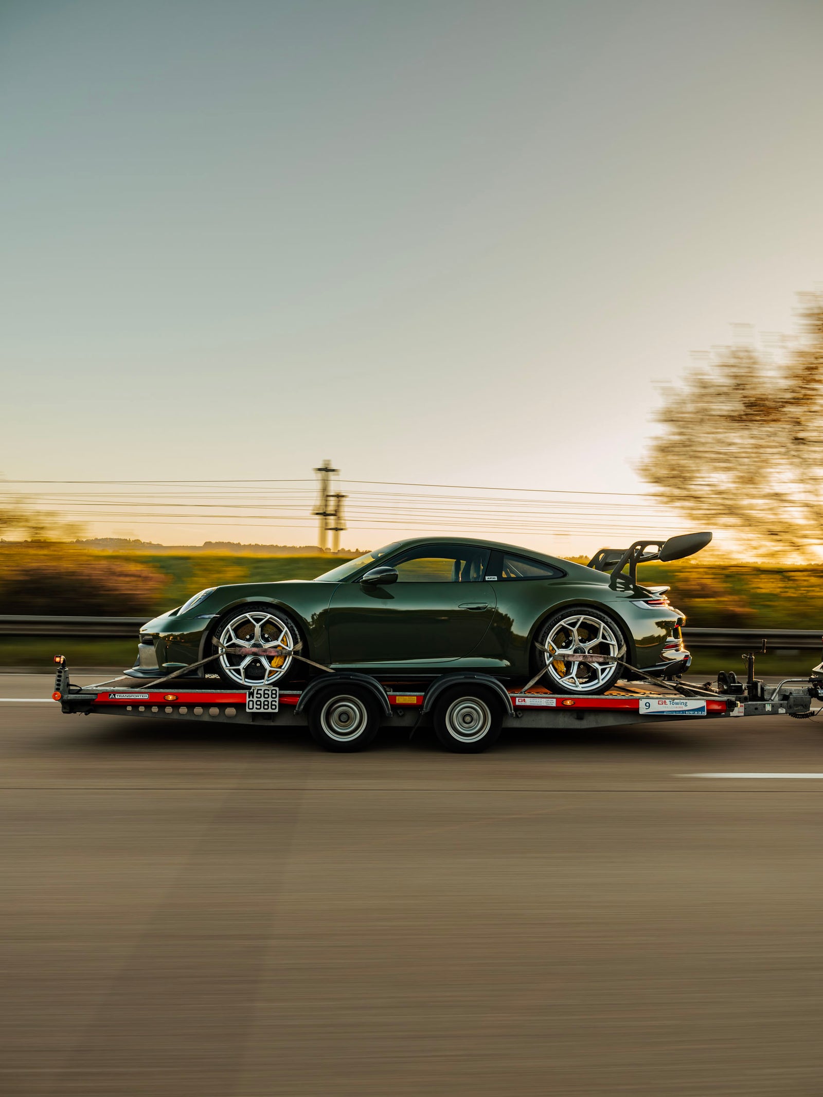 ADRO Porsche 992 GT3 on trailer on motorway