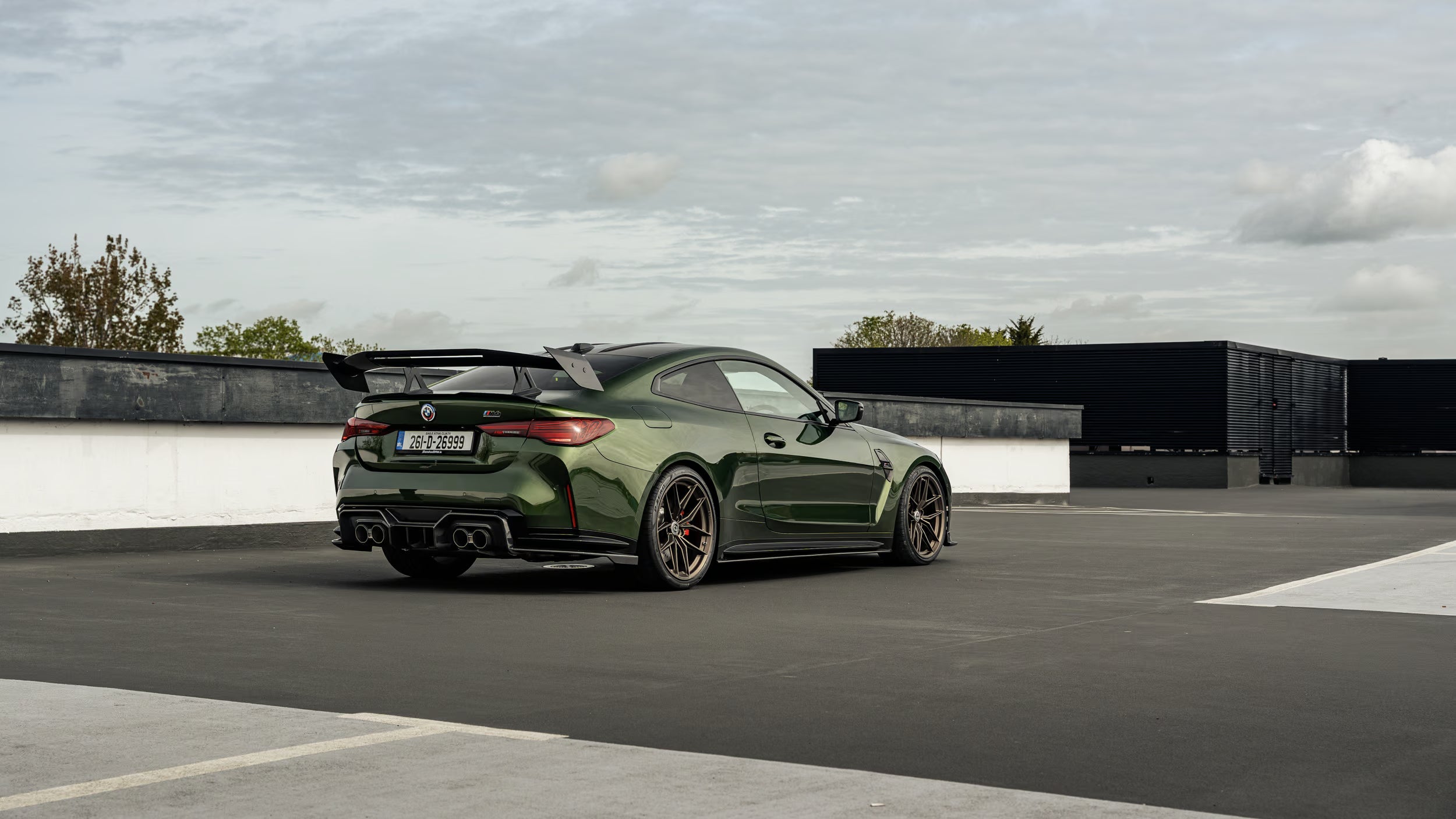 Modified Anglesea Green BMW G82 M4 LCI with ADRO rear wing, rear diffuser, akrapovic exhaust system, sat on HRE FF21 wheels and Eibach lowering springs