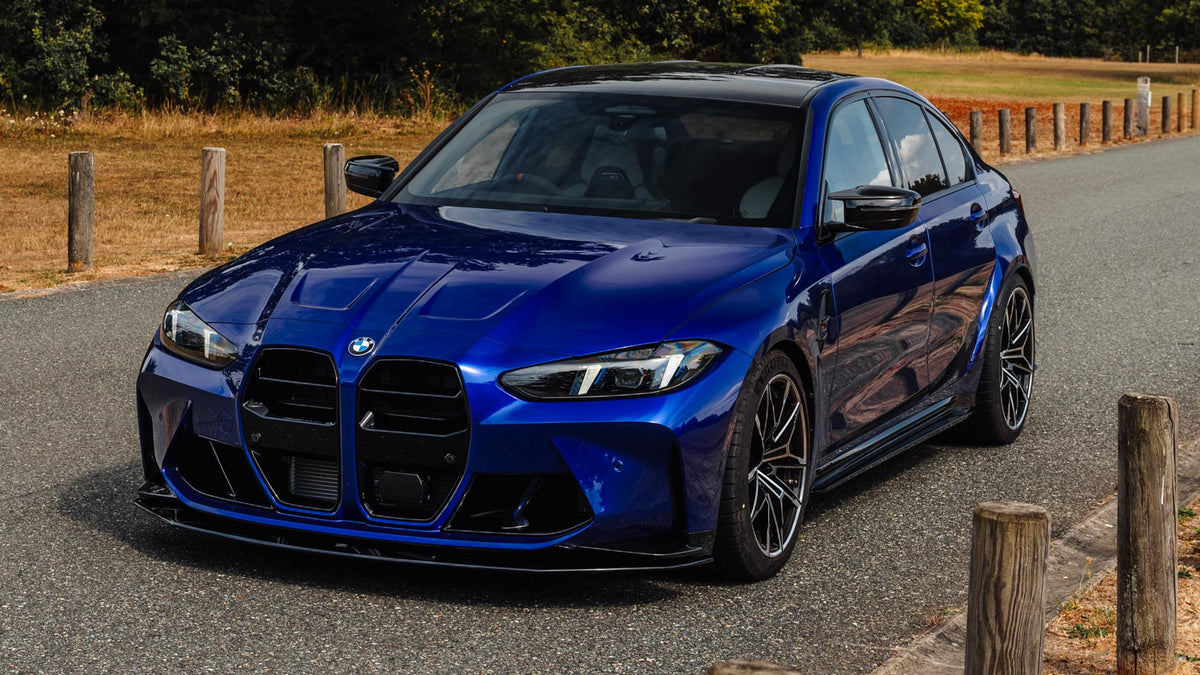 Front of Modified San Marino Blue BMW G80 M3 LCI with Zaero gloss black front grille, front bumper ducts, and front splitter, side skirts.