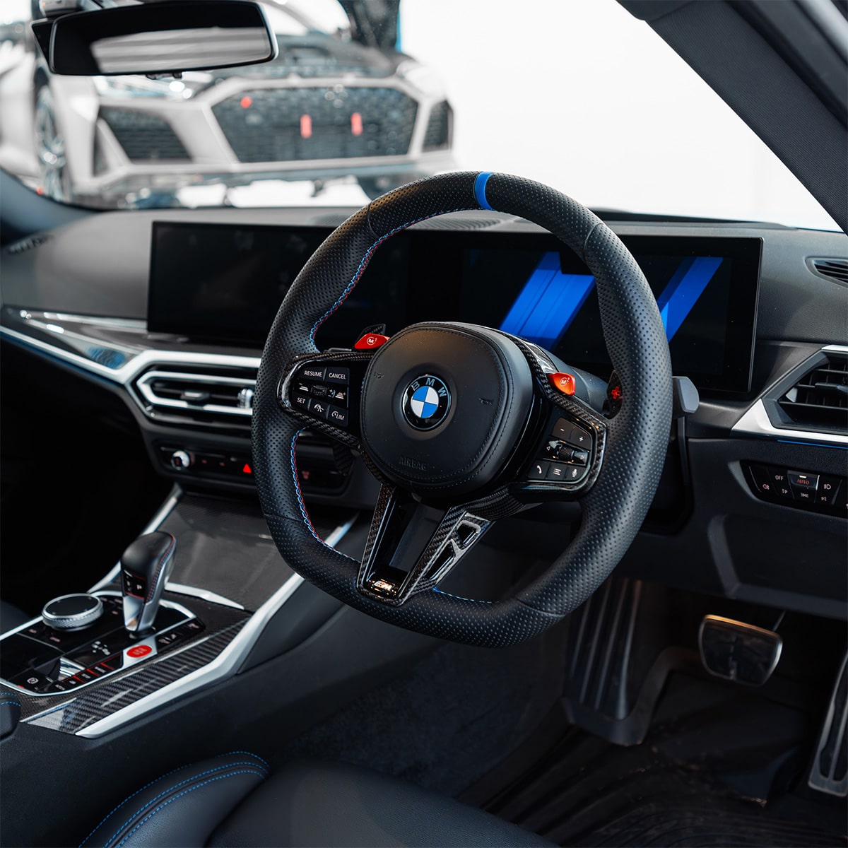 Car interior with steering wheel featuring BMW logo
