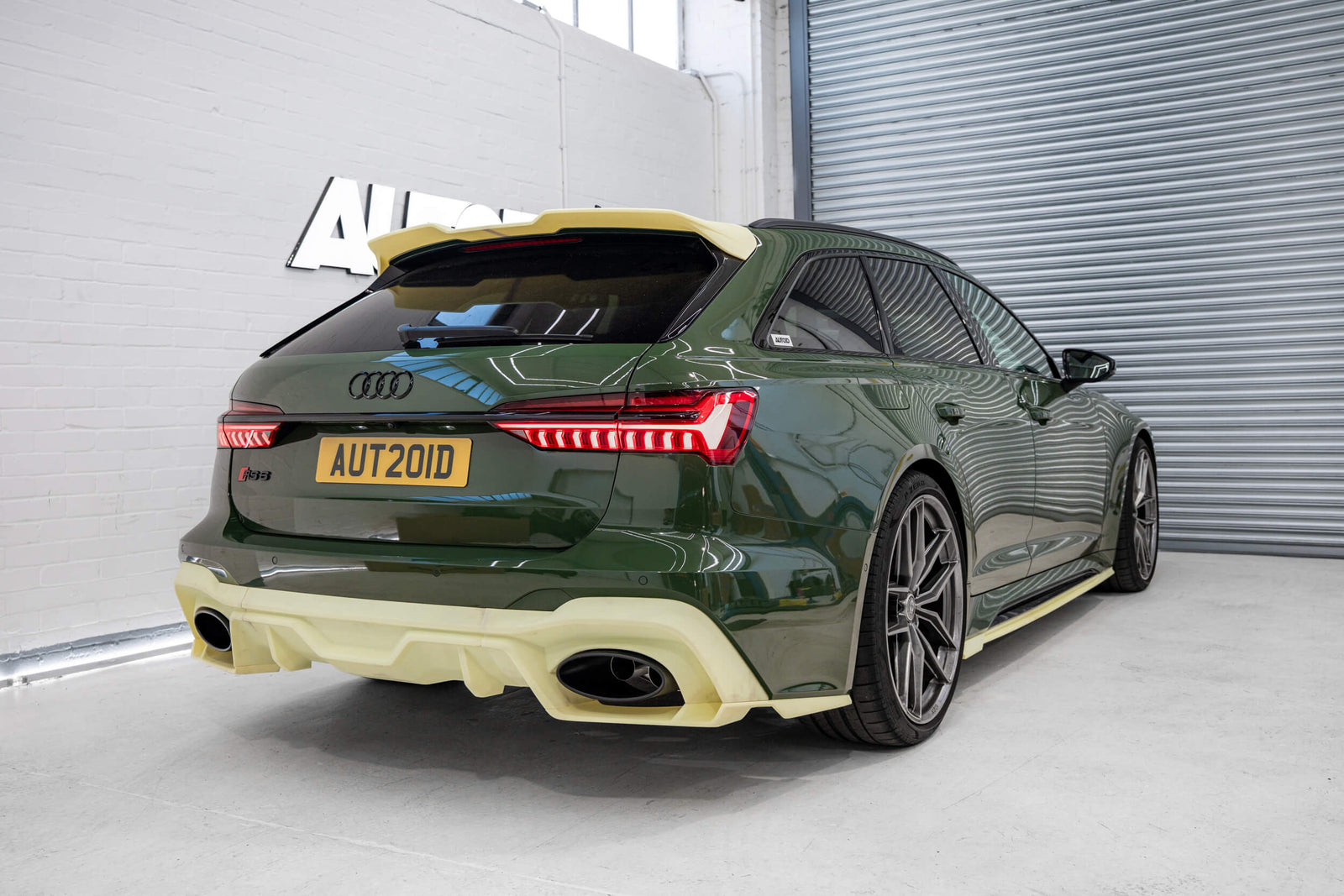 3D printed prototype body kit by Trevora on modified green Audi C8 RS6 in Autoid shop.