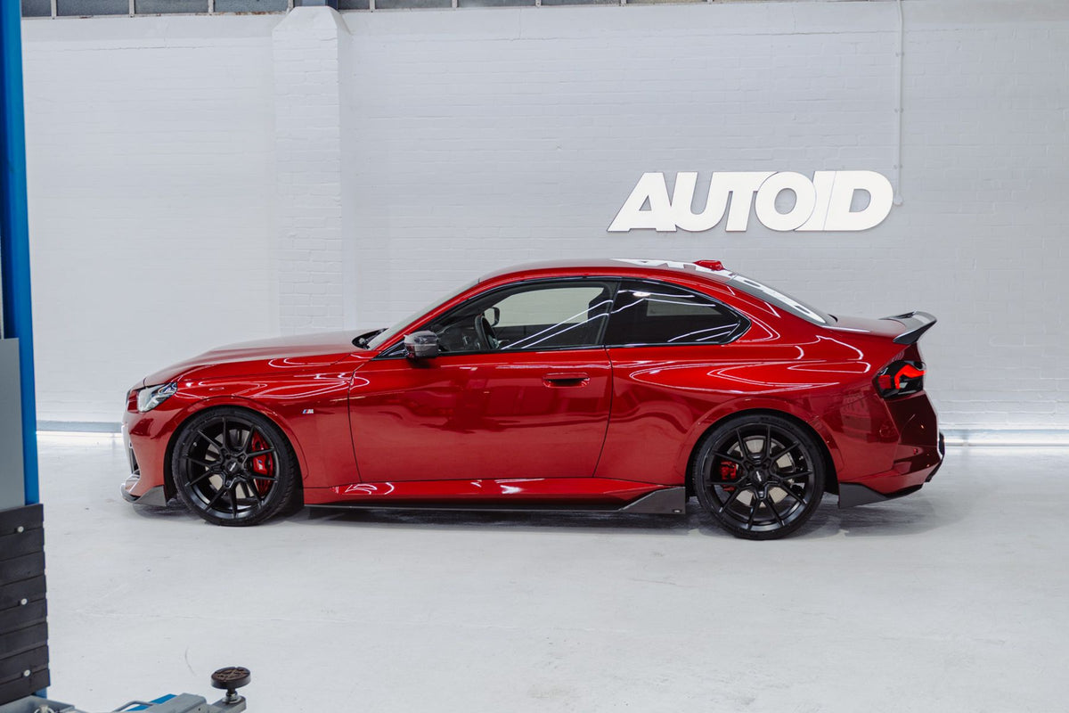 BMW G42 M240i red side profile with ADRO carbon fibre full length side skirts fitted