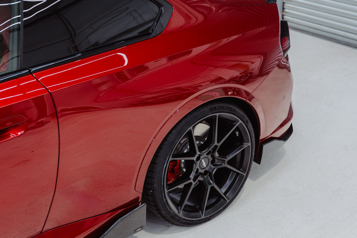 ADRO carbon fibre side skirt detail on BMW G42 M240i behind rear wheel gloss finish
